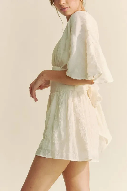 Batwing Sleeve Waist Belt Romper with Ruched and Ruffled Details.