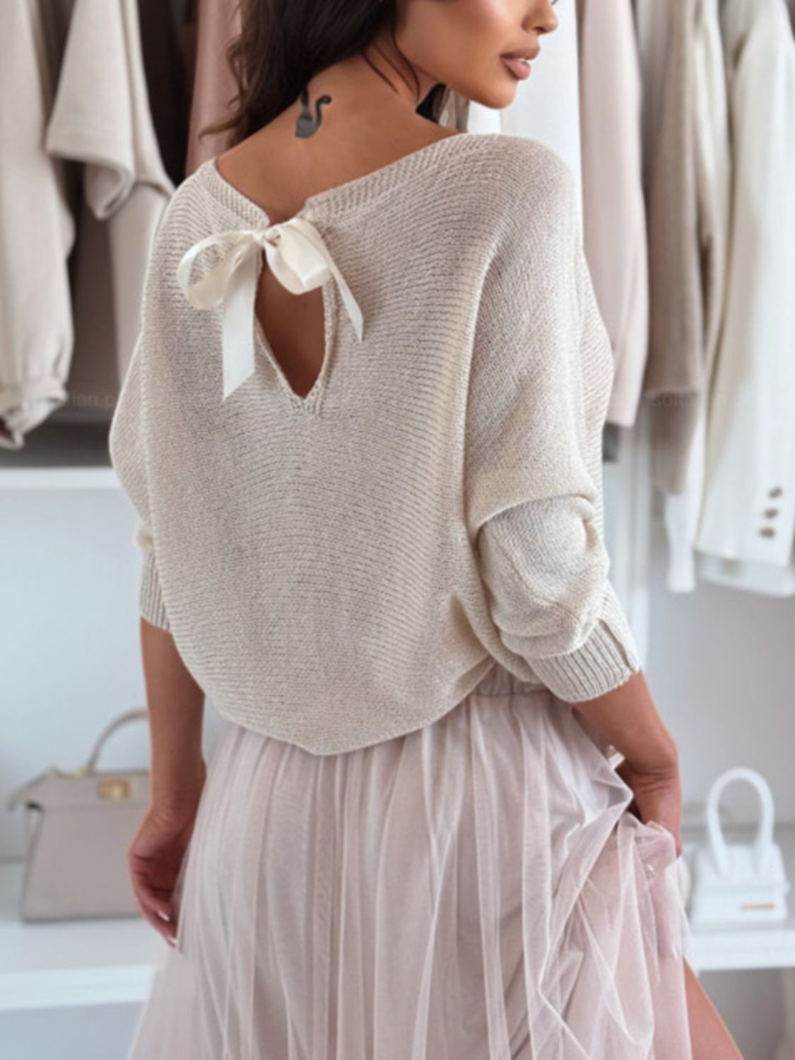 Bow back boat neck batwing sleeve sweater.