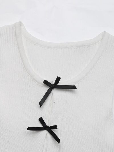 Round neck tank top with bow detail on the front.