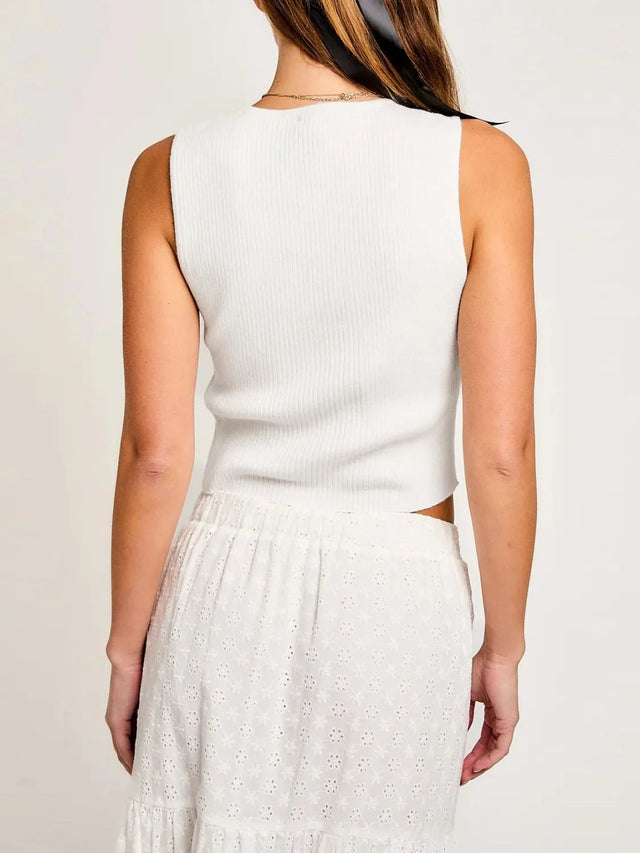 Cropped round neck tank top with bow detail.