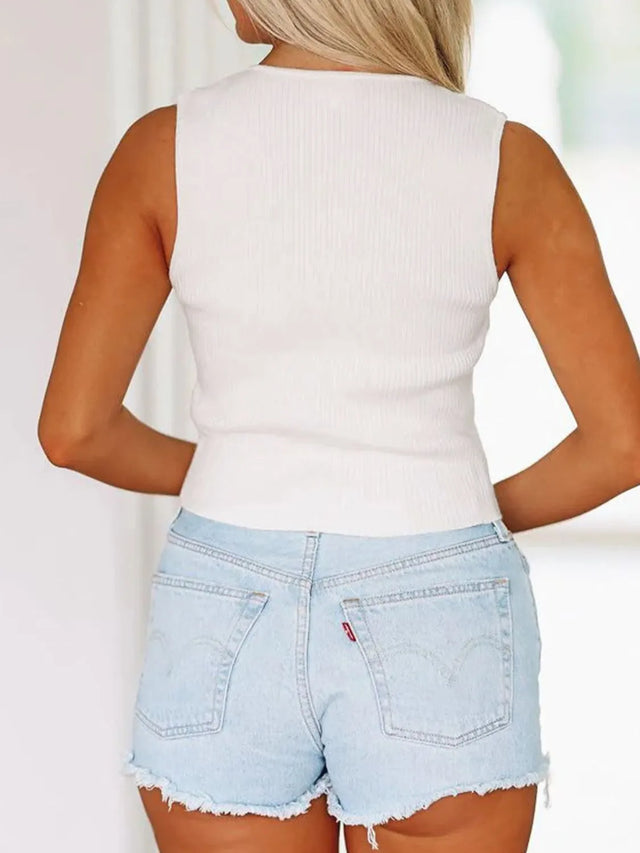 Cropped round neck tank top with bow detail.