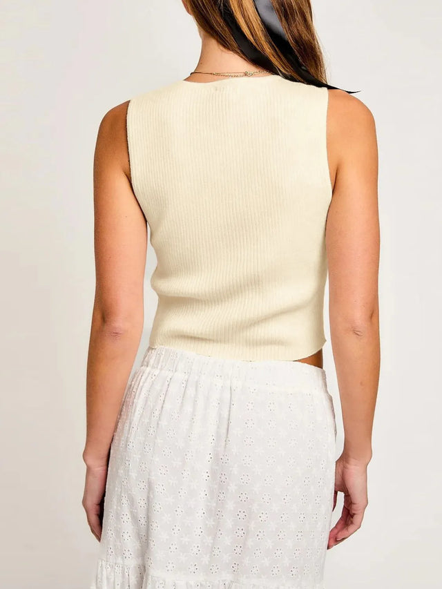 Cropped round neck tank top with bow detail.