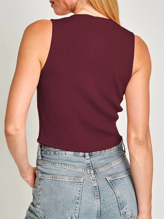 Cropped round neck tank top with bow detail.