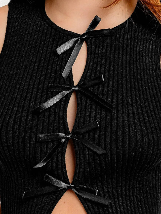 Cropped round neck tank top with bow detail.