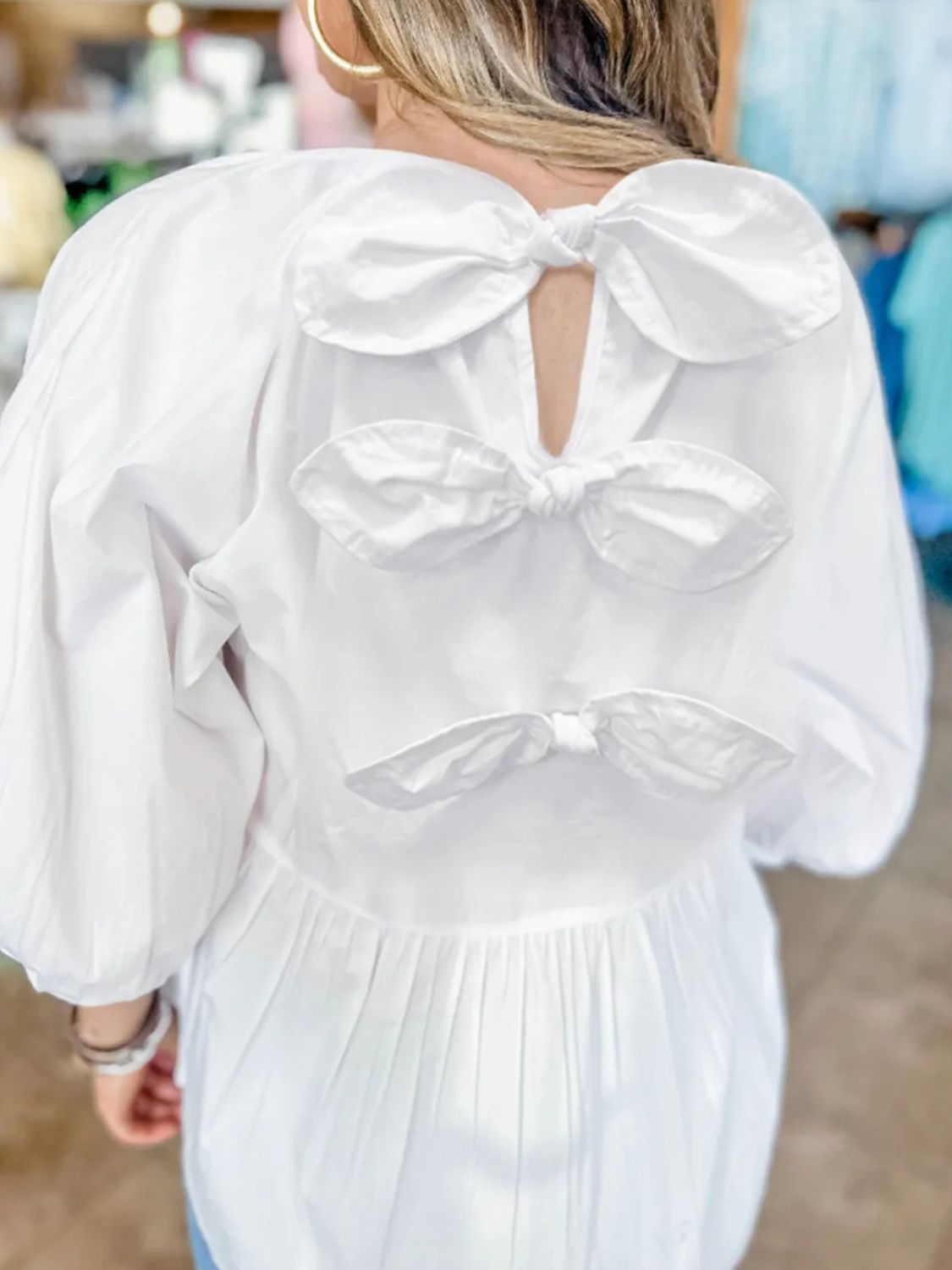 Bow round neck three-quarter sleeve blouse.