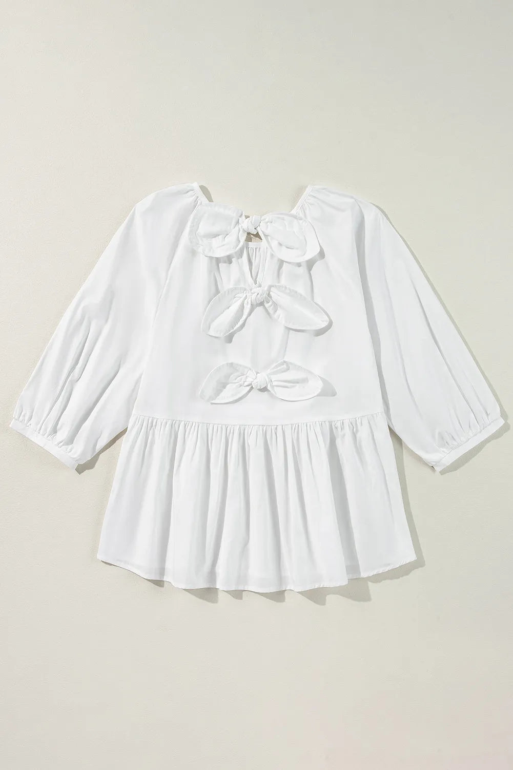 Bow round neck three-quarter sleeve blouse.