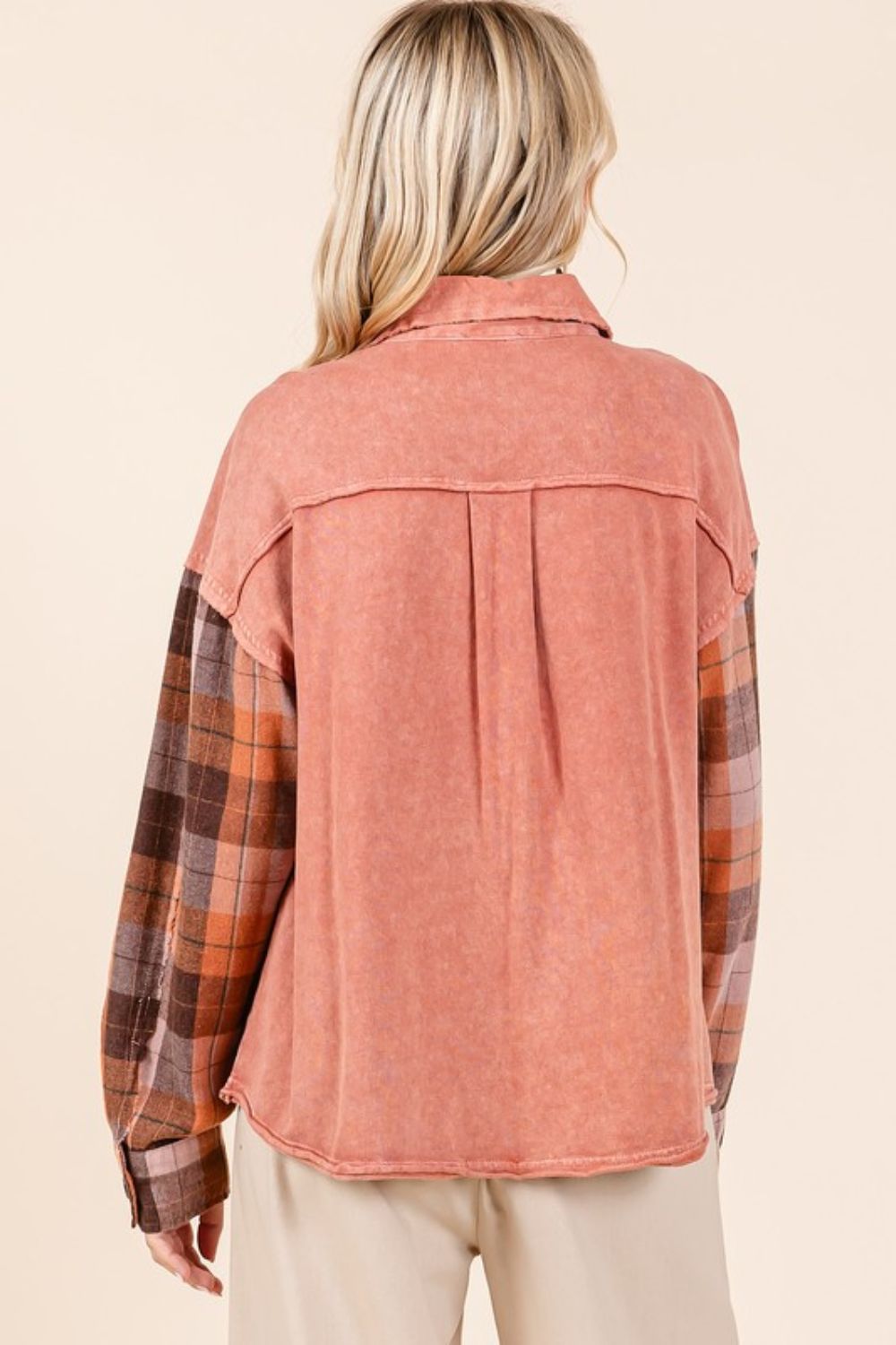 Button down contrast plaid patchwork shacket with exposed seams and pockets.