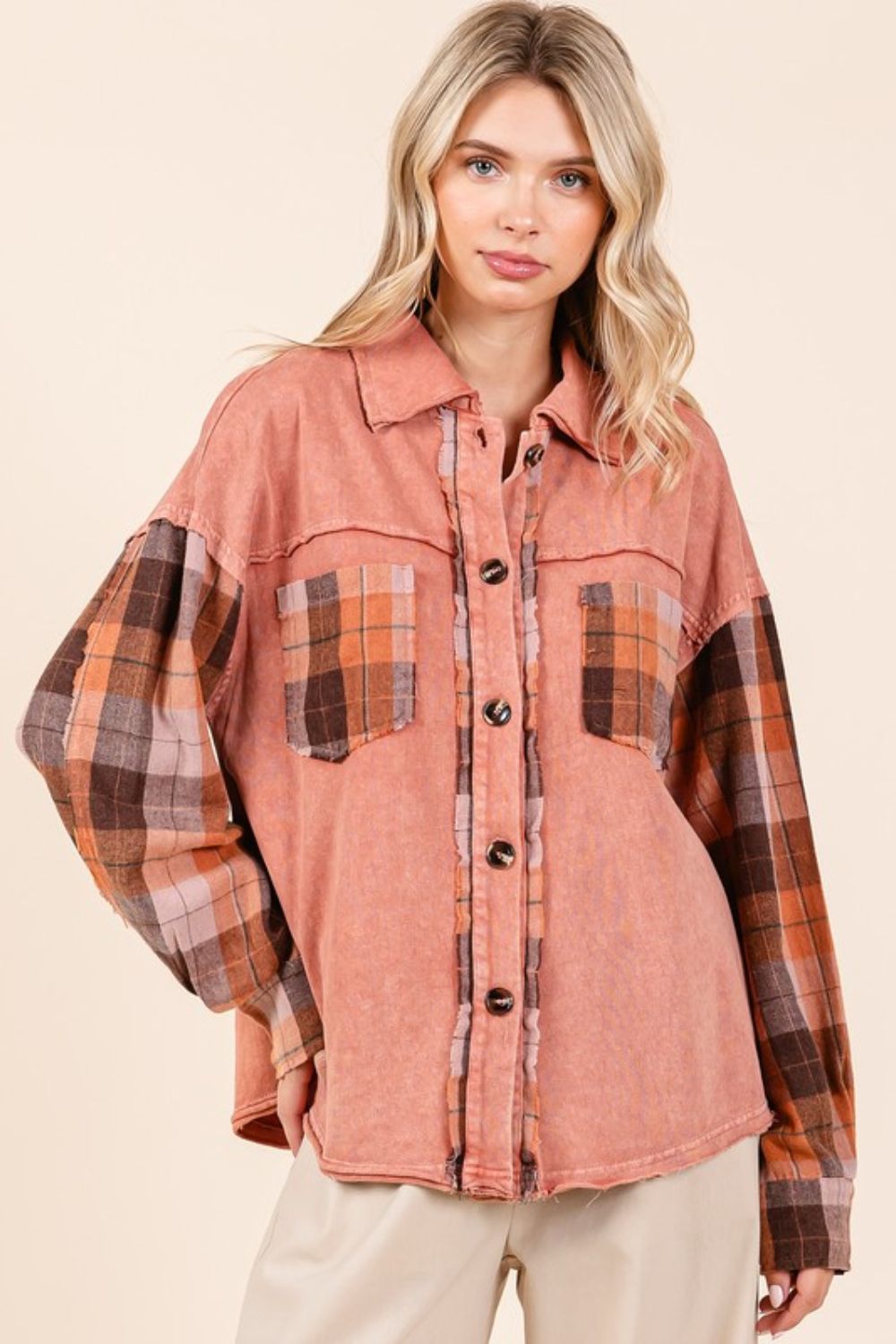 Button down contrast plaid patchwork shacket with exposed seams and pockets.