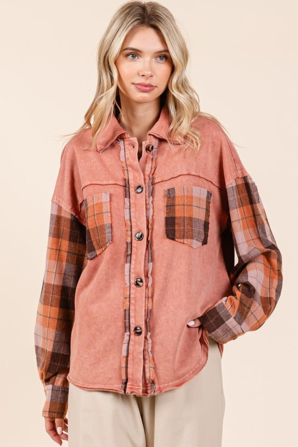 Button down contrast plaid patchwork shacket with exposed seams and pockets.