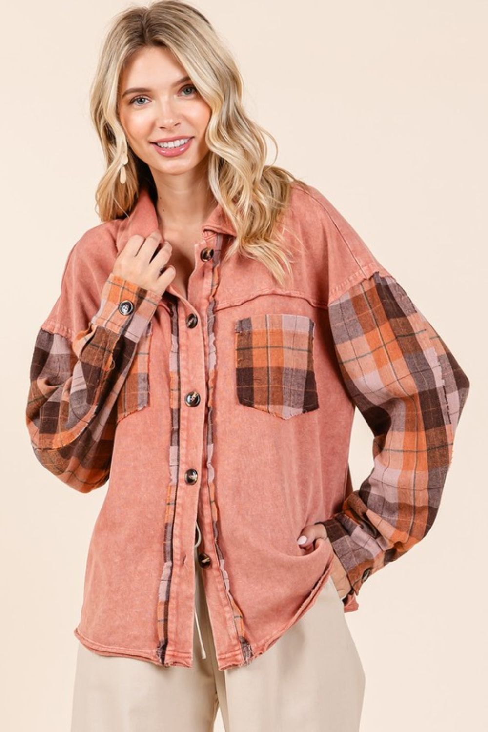 Button down contrast plaid patchwork shacket with exposed seams and pockets.