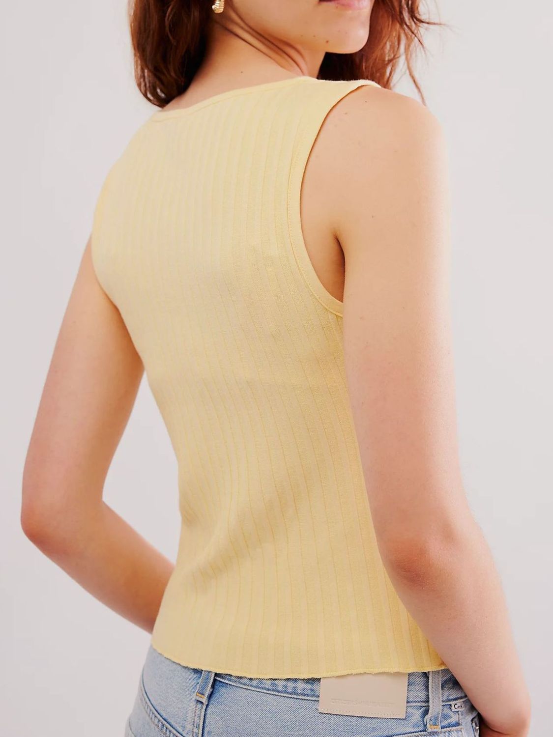 Button down round neck sweater vest with moderate stretch.