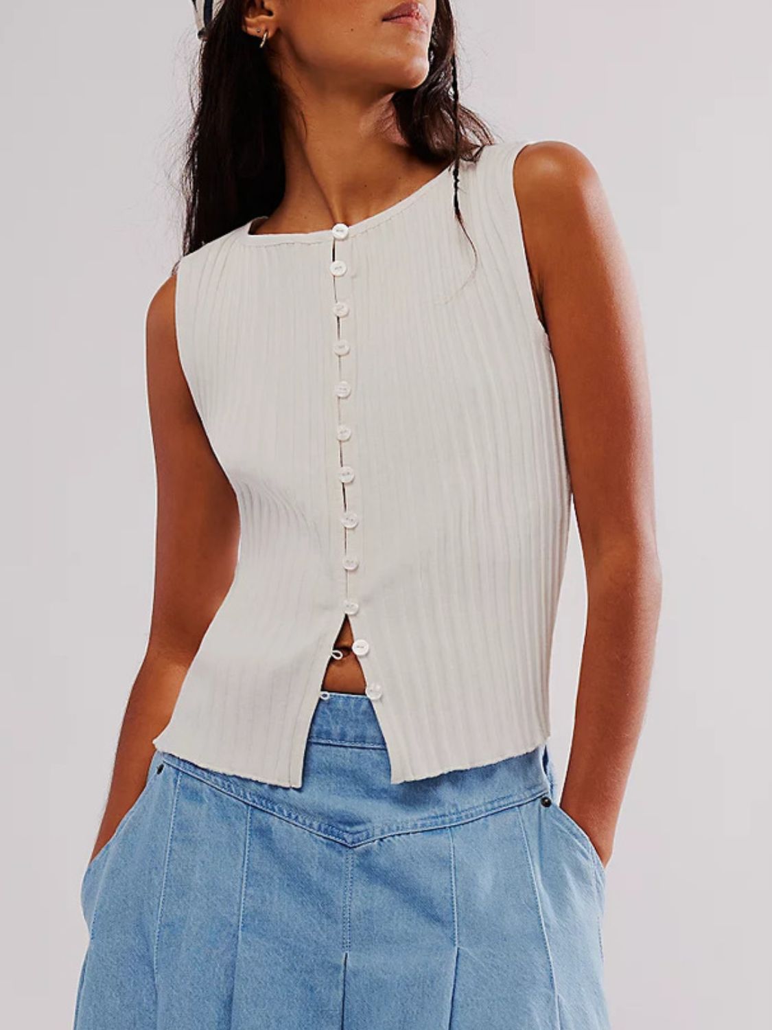 Button down round neck sweater vest with moderate stretch.