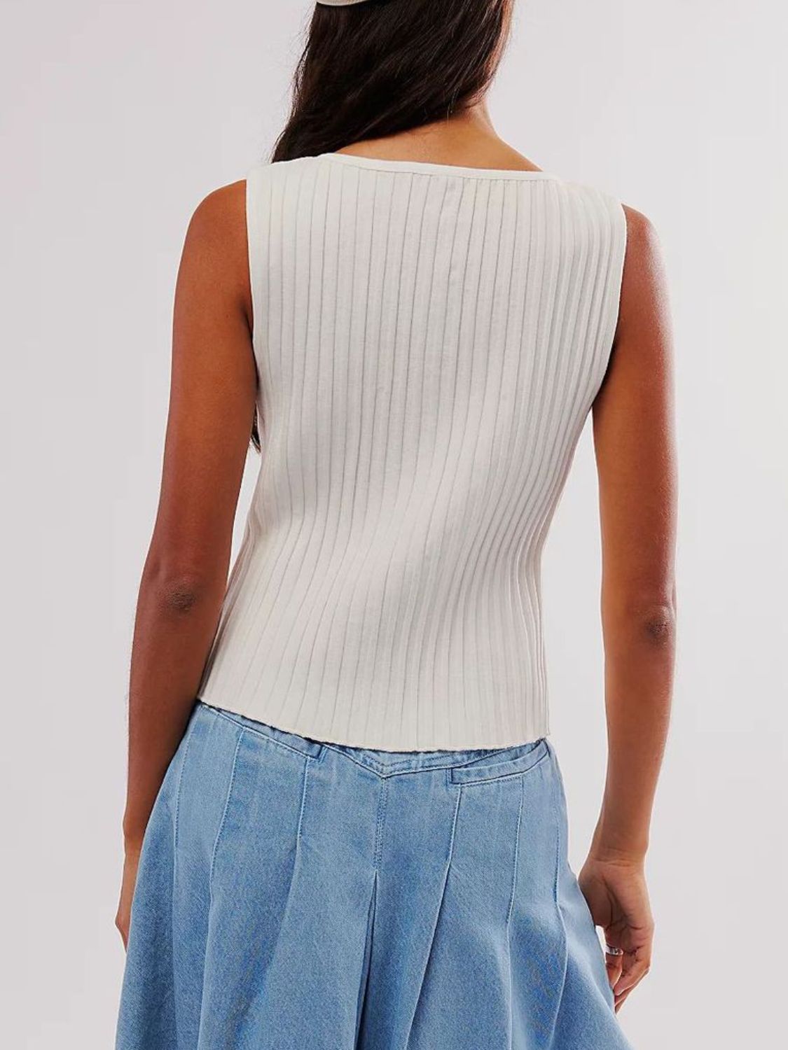 Button down round neck sweater vest with moderate stretch.
