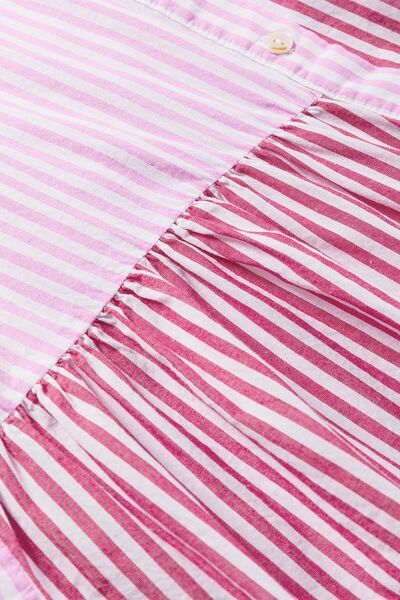 Button down striped ruffled hem shirt.