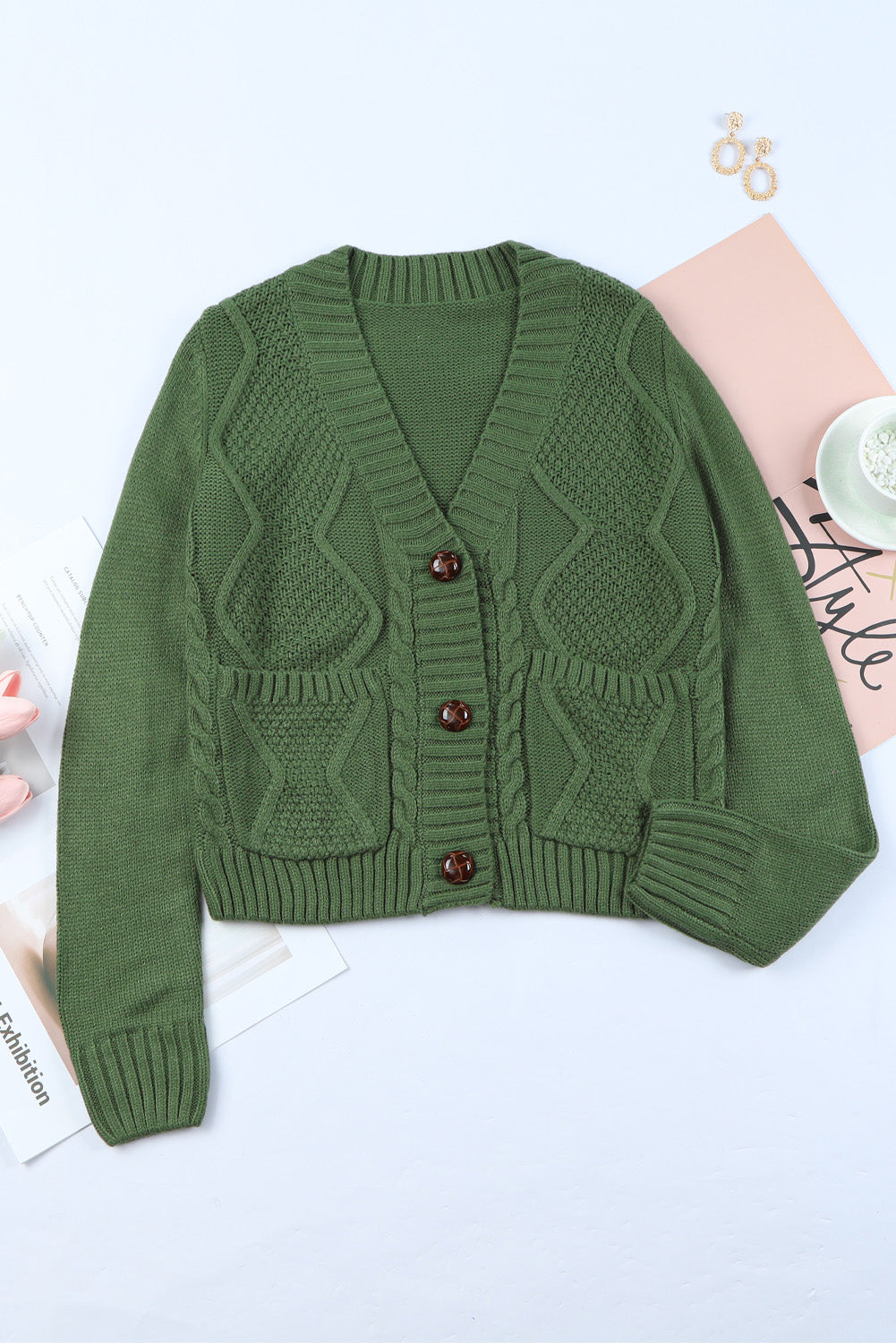 Cable-knit button down V-neck cardigan with pockets.
