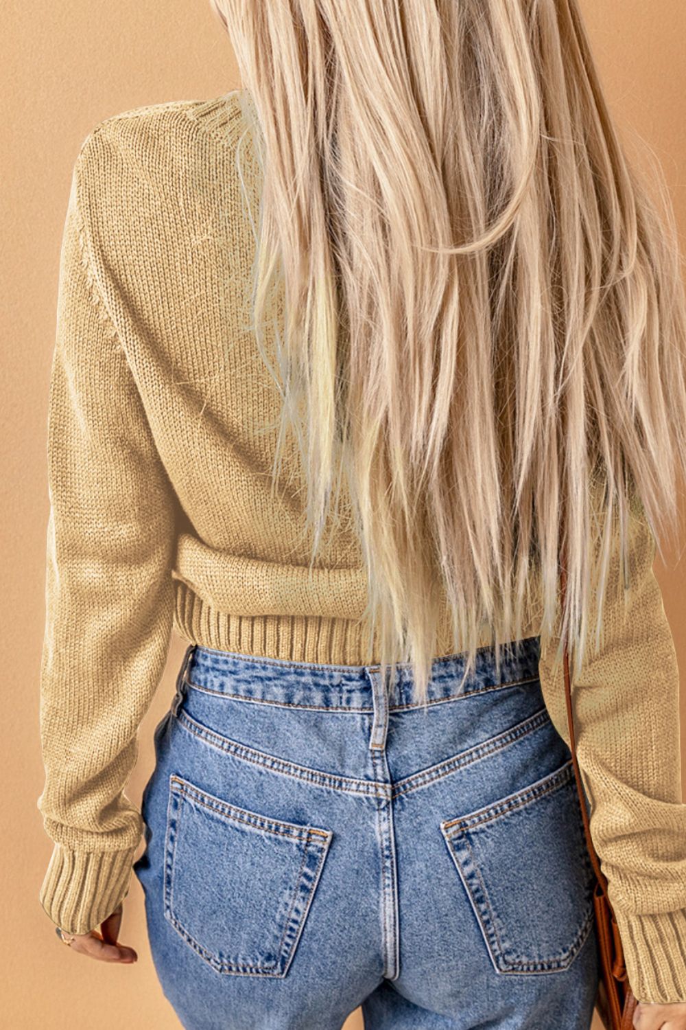 Cable-knit button down V-neck cardigan with pockets.