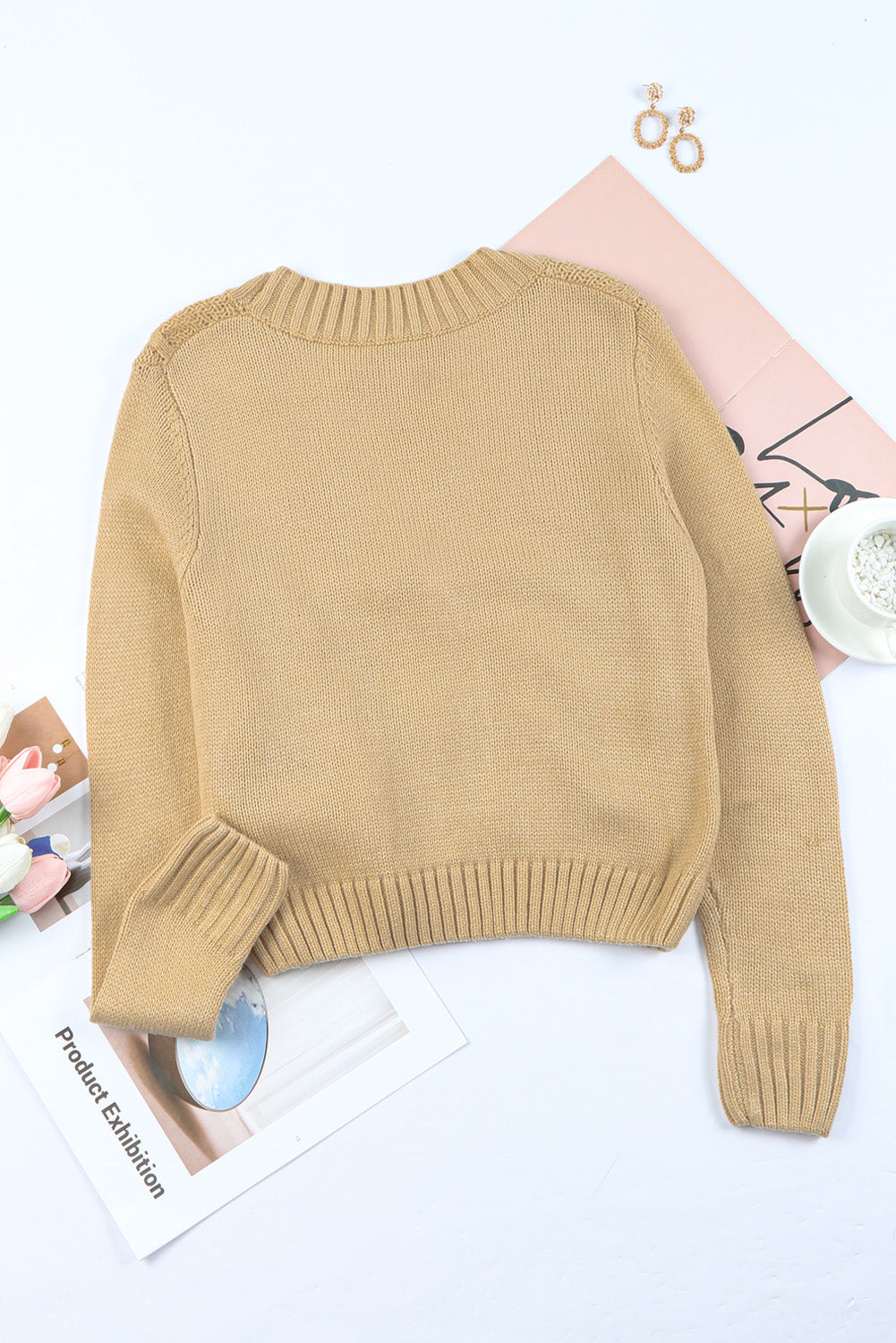 Cable-knit button down V-neck cardigan with pockets.