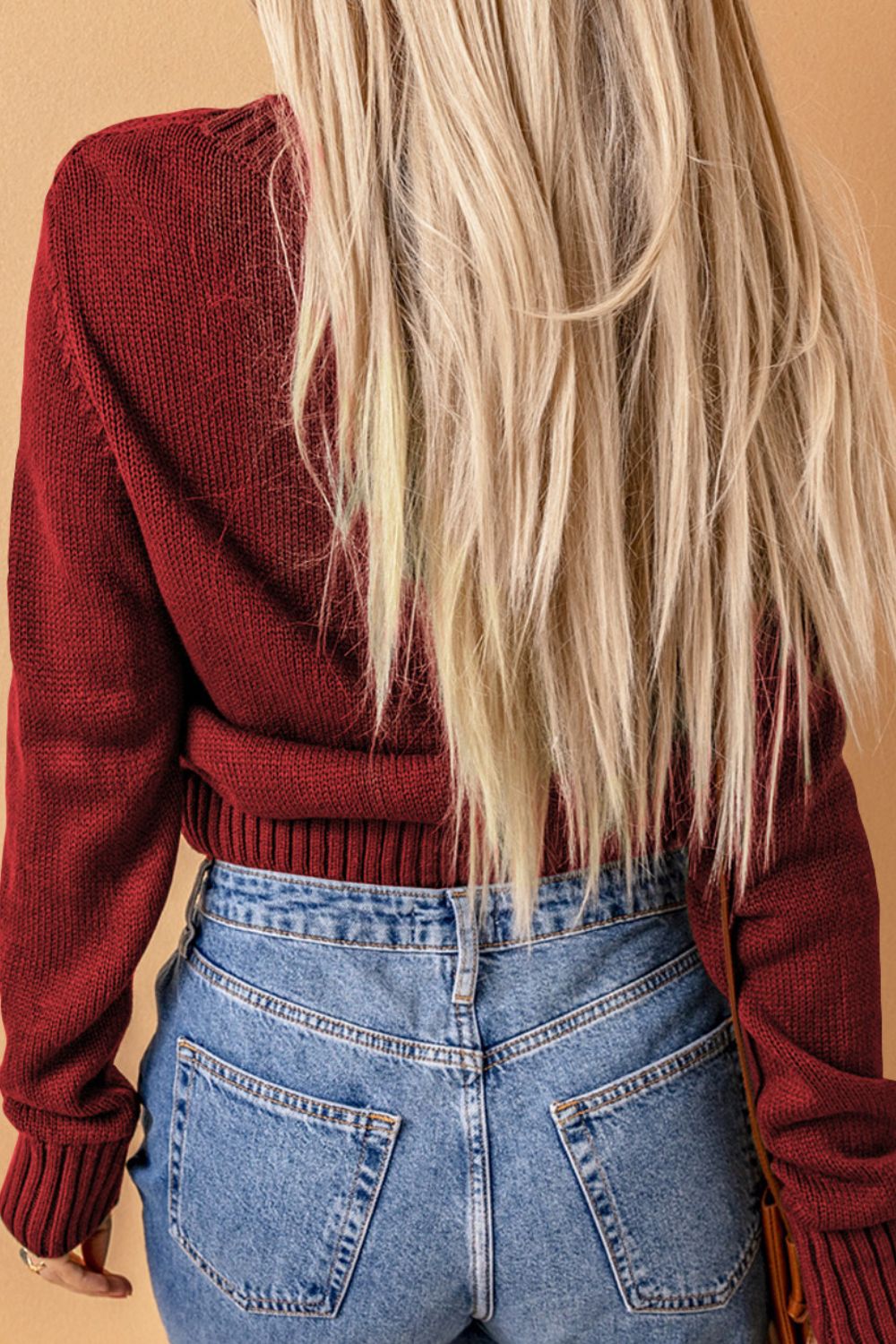 Cable-knit button down V-neck cardigan with pockets.