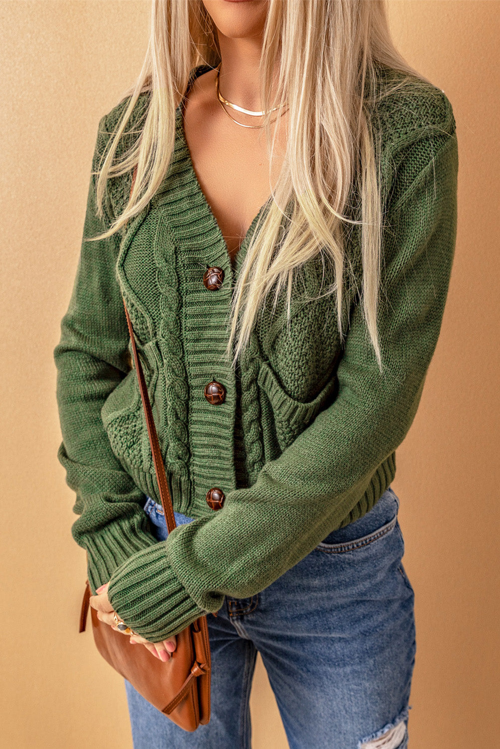 Cable-knit button down V-neck cardigan with pockets.