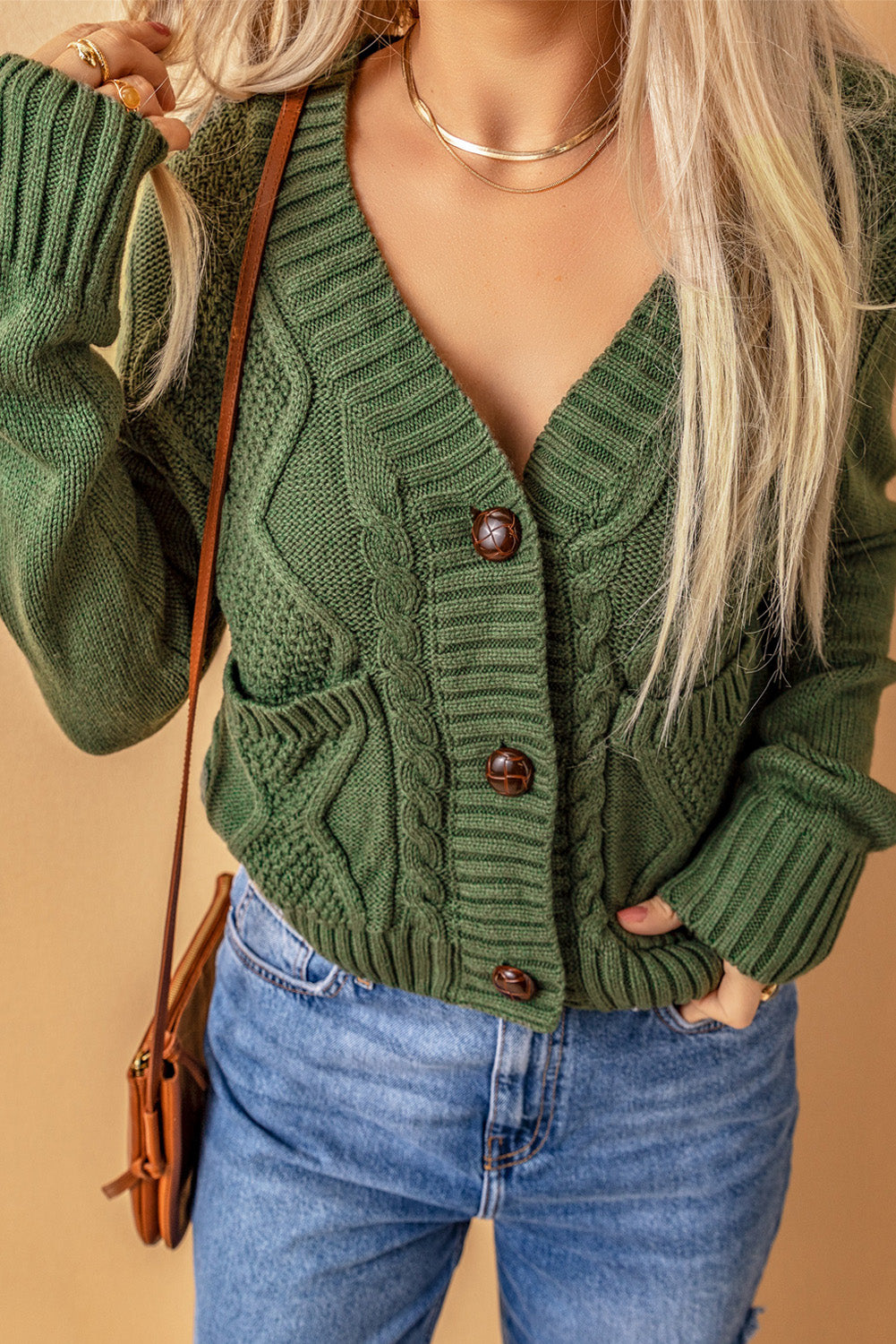 Cable-knit button down V-neck cardigan with pockets.