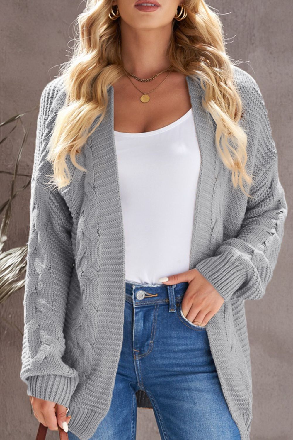 Cable-knit open front cardigan.