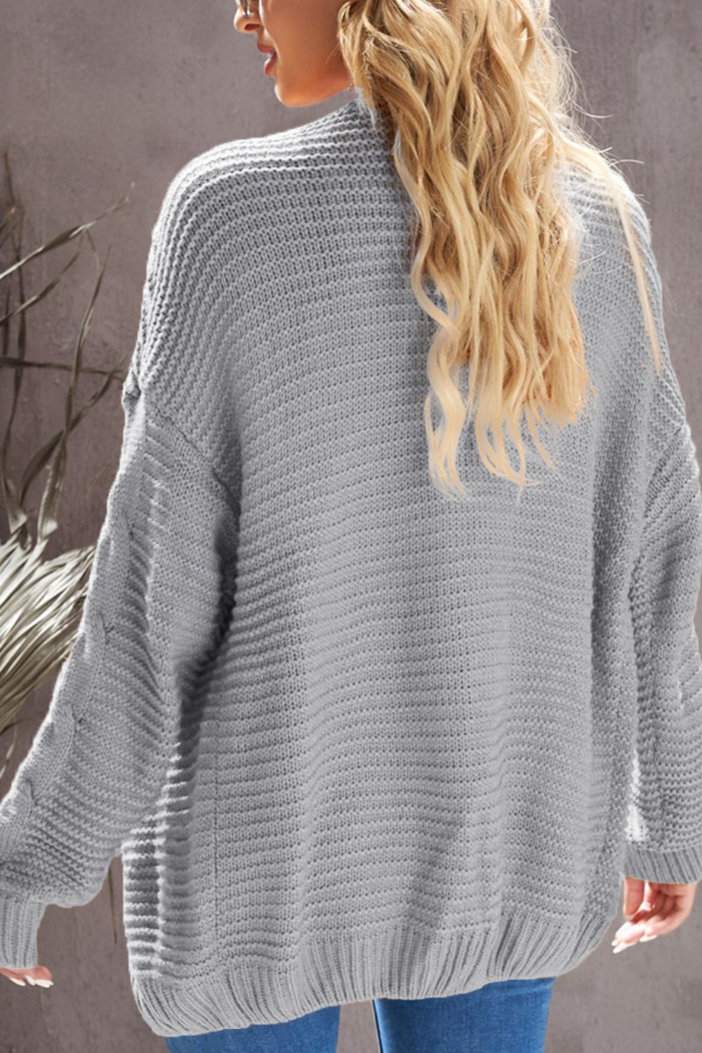 Cable-knit open front cardigan.