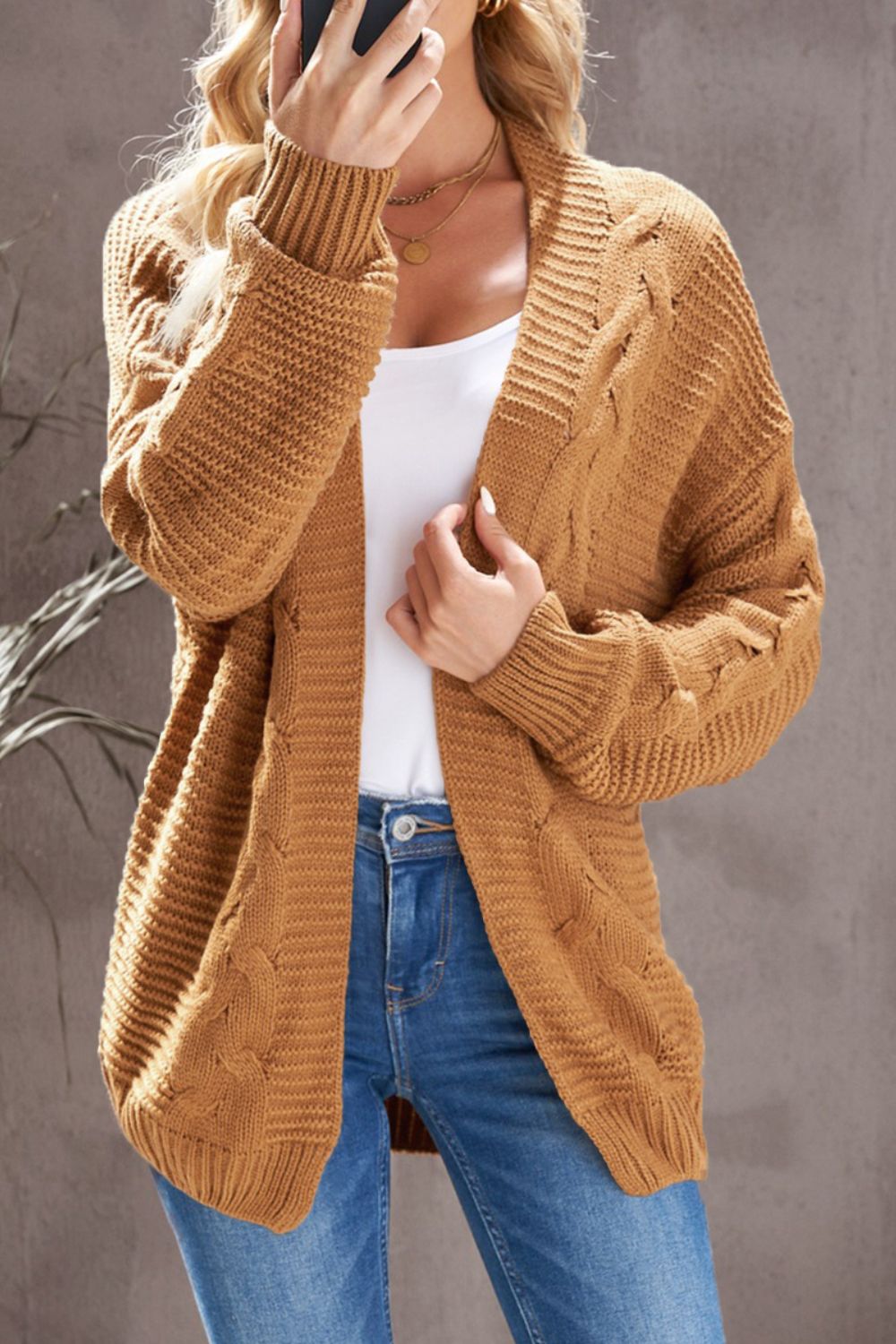 Cable-knit open front cardigan.