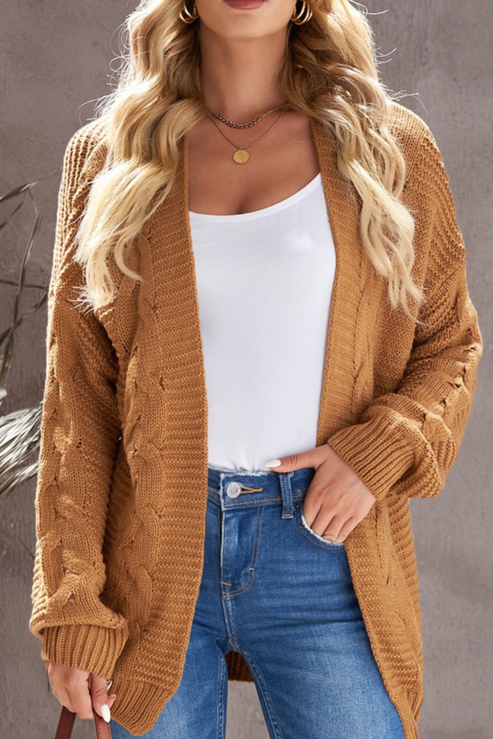 Cable-knit open front cardigan.