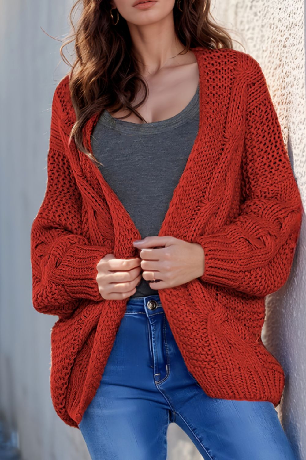 Cable-knit open front cardigan.