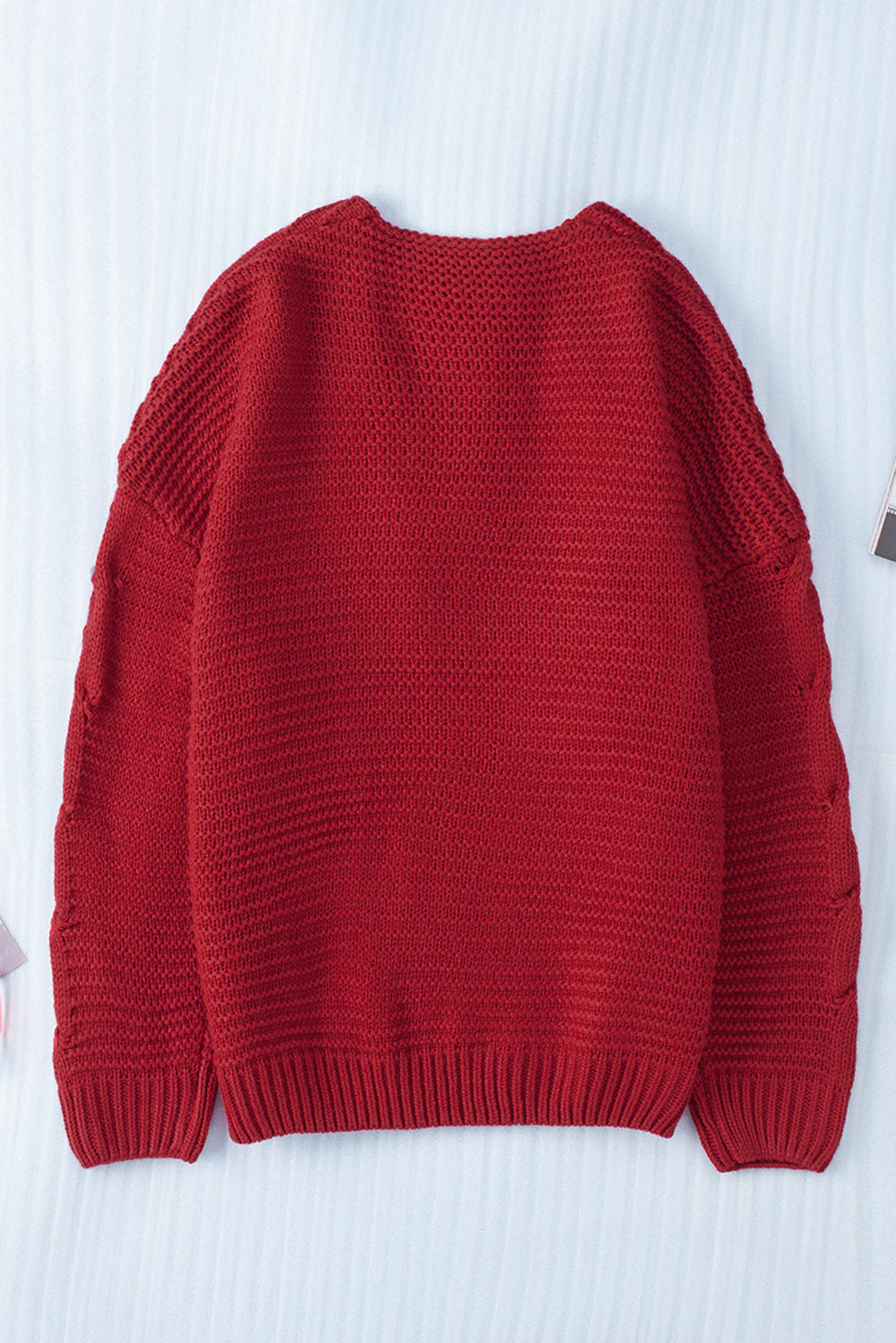 Cable-knit open front cardigan.
