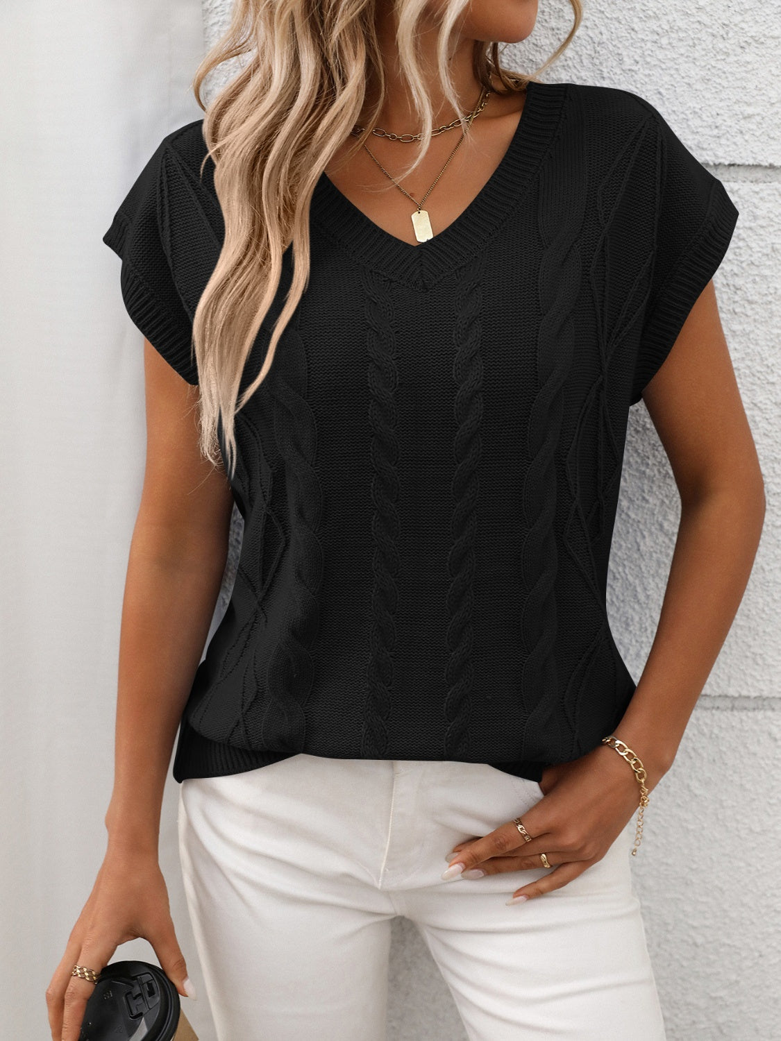 Cable-knit V-neck short sleeve knit top.