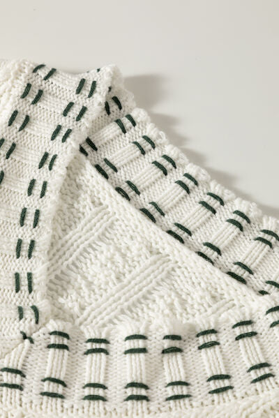 Cable-knit V-neck sweater vest.