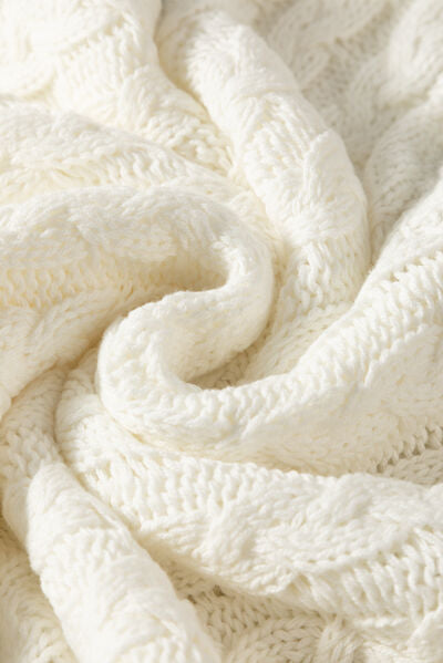 Cable-knit V-neck sweater vest.