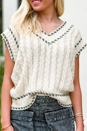 Cable-knit V-neck sweater vest.
