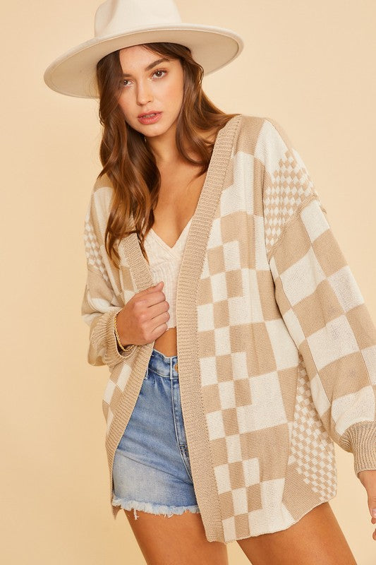 Checkered open front drop shoulder cardigan with exposed seams and ribbed details.