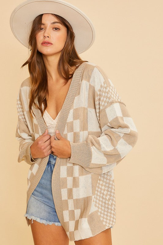 Checkered open front drop shoulder cardigan with exposed seams and ribbed details.