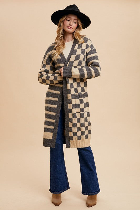 Checkered and striped open front long sleeve cardigan with ribbed pockets.