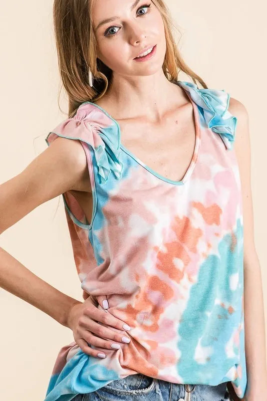 Circular tie dye knit V-neck top with ruffle details.