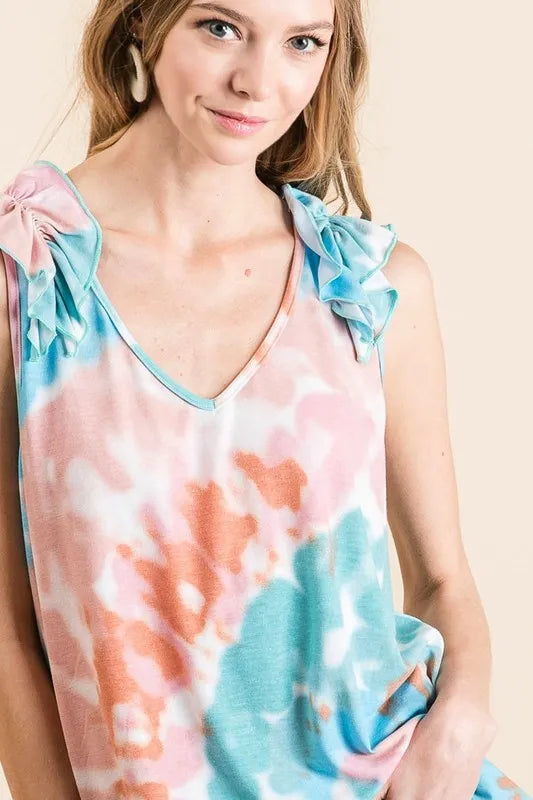 Circular tie dye knit V-neck top with ruffle details.