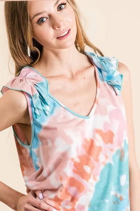 Circular tie dye knit V-neck top with ruffle details.