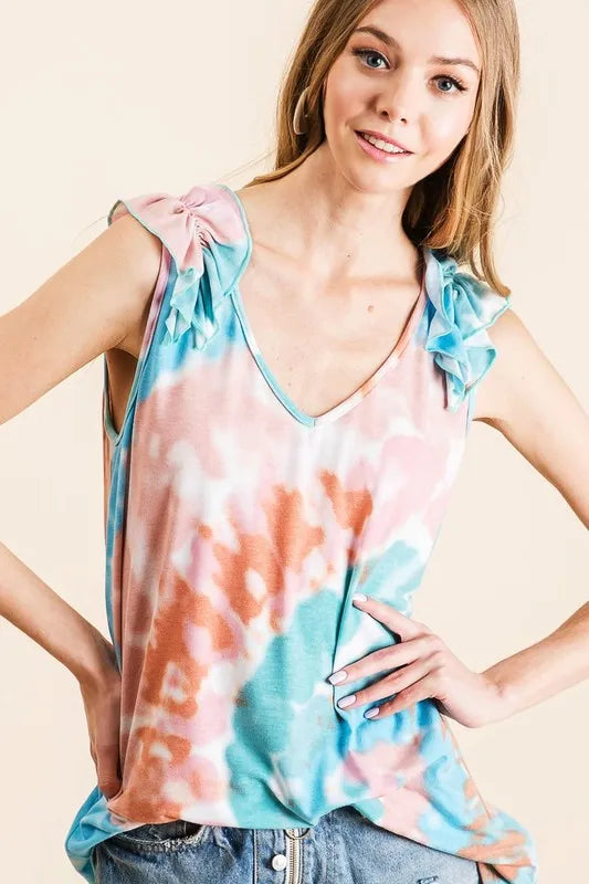 Circular tie dye knit V-neck top with ruffle details.