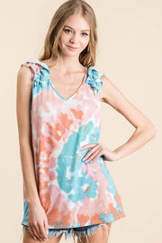 Circular tie dye knit V-neck top with ruffle details.