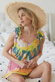 Circular tie dye knit V-neck top with ruffle details.