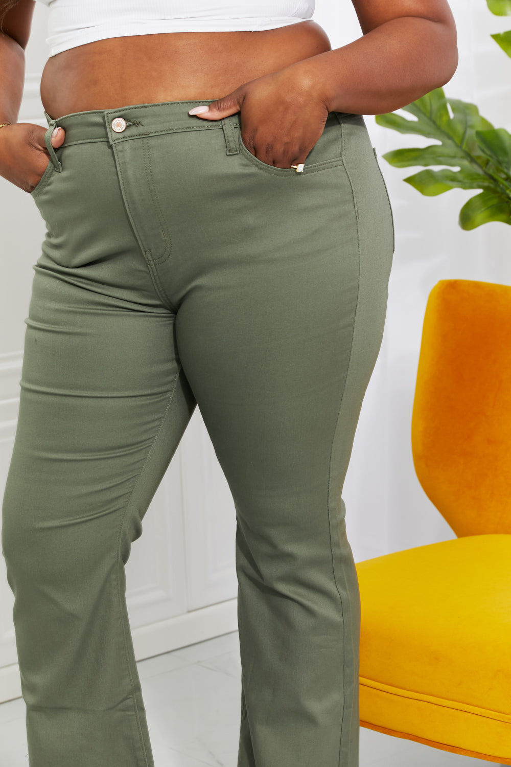 Clementine high-rise bootcut jeans in olive with pockets, moderate stretch.