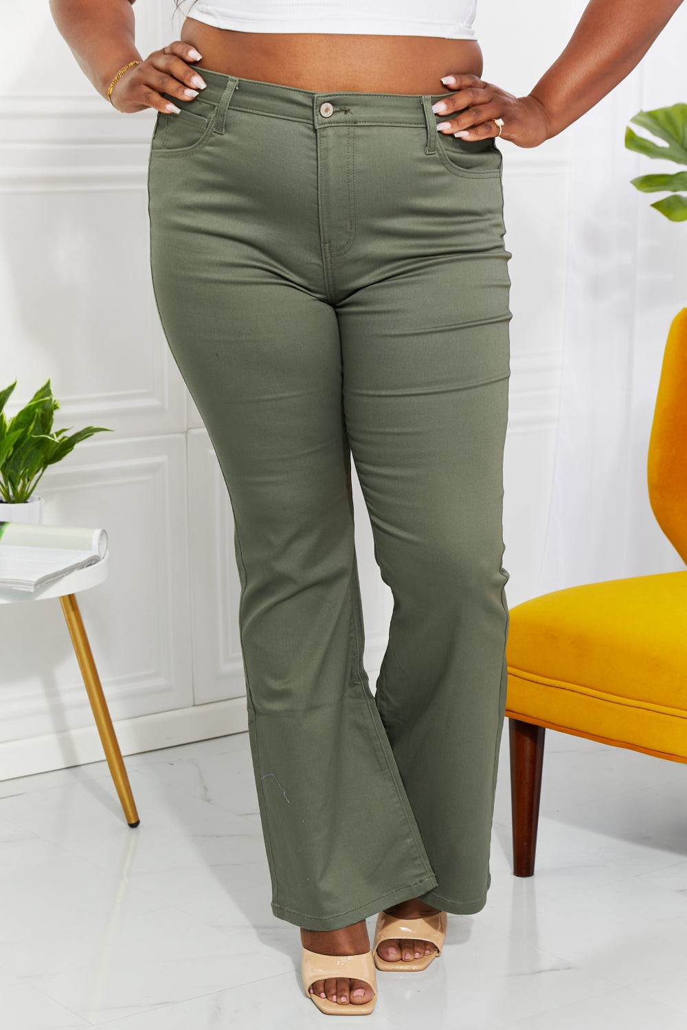 Clementine high-rise bootcut jeans in olive with pockets, moderate stretch.