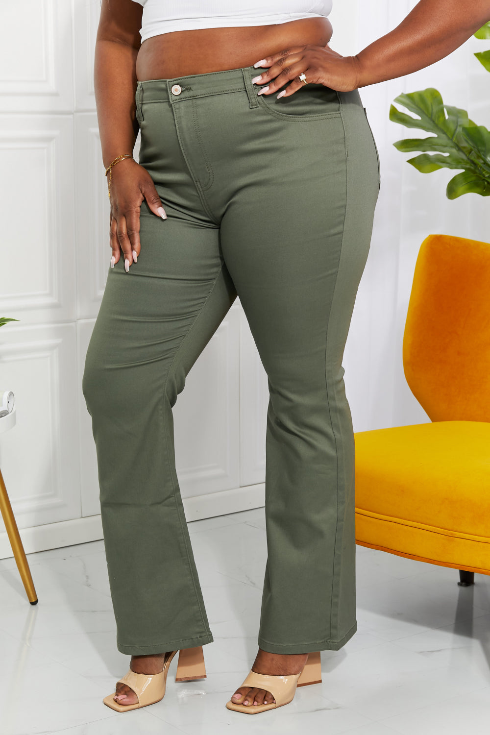 Clementine high-rise bootcut jeans in olive with pockets, moderate stretch.