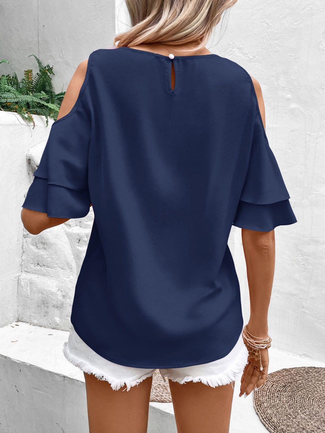 Cold shoulder flounce sleeve blouse with ruffles.