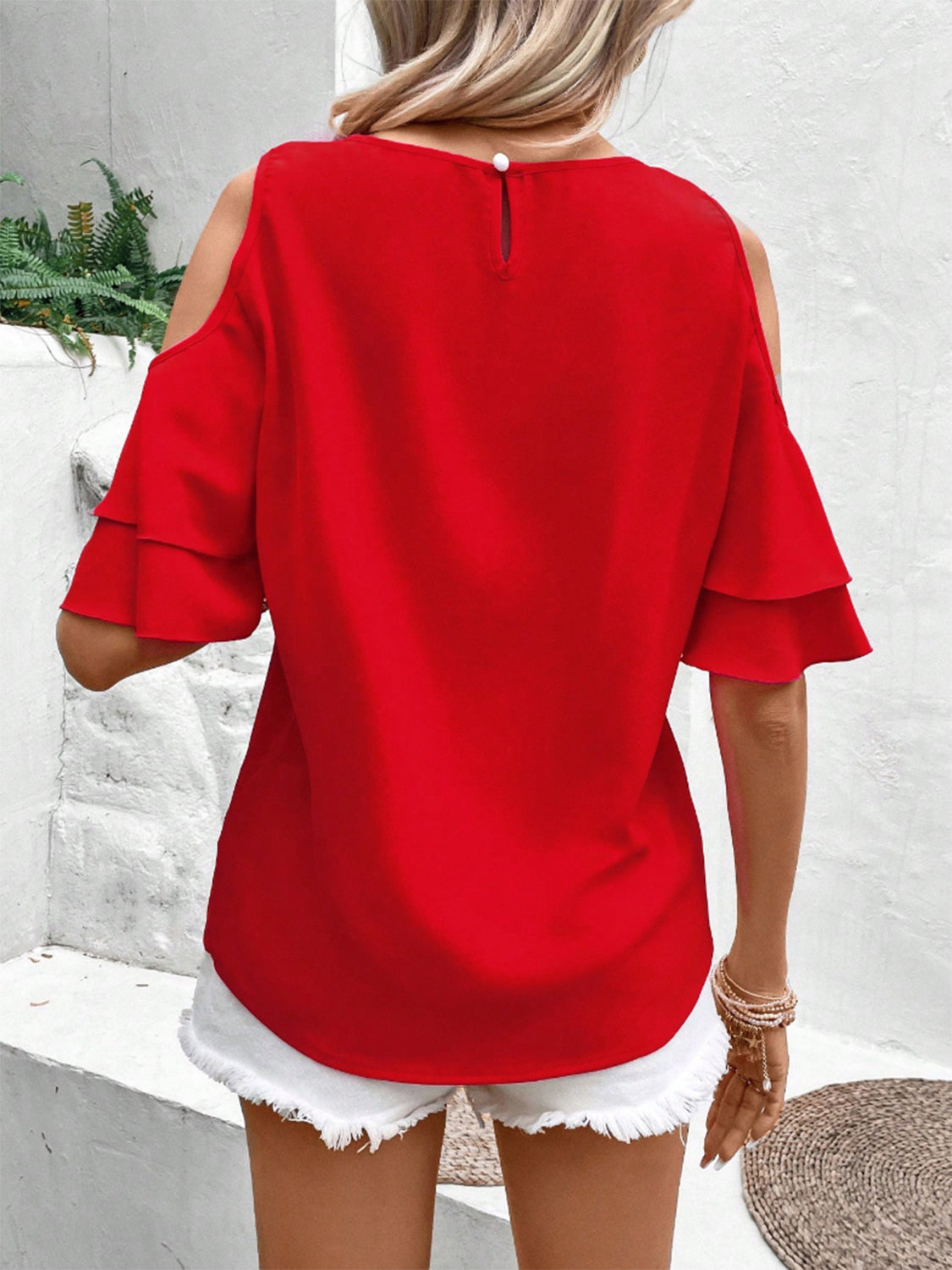 Cold shoulder flounce sleeve blouse with ruffles.