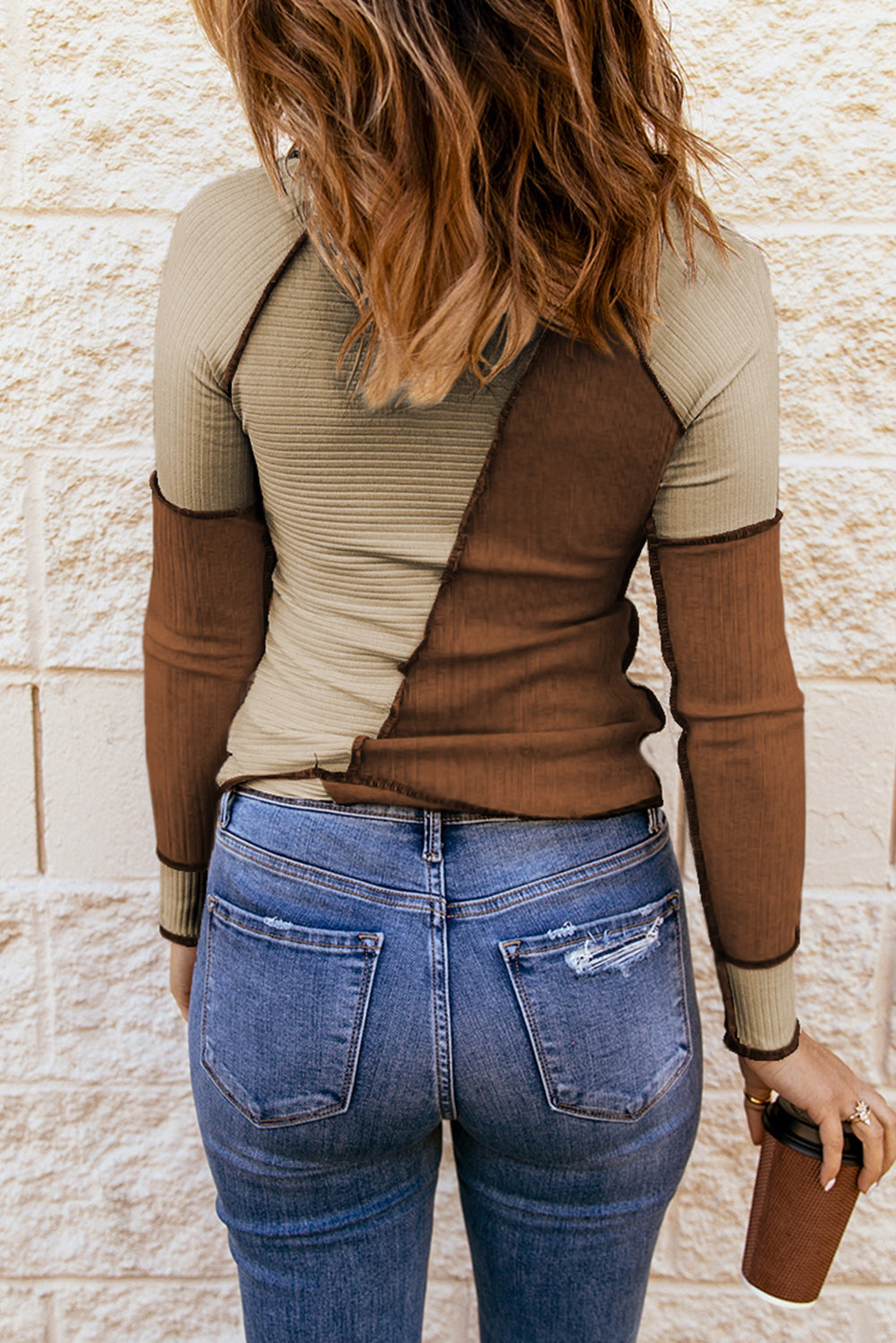 Color block exposed seam knit top with ribbed design.