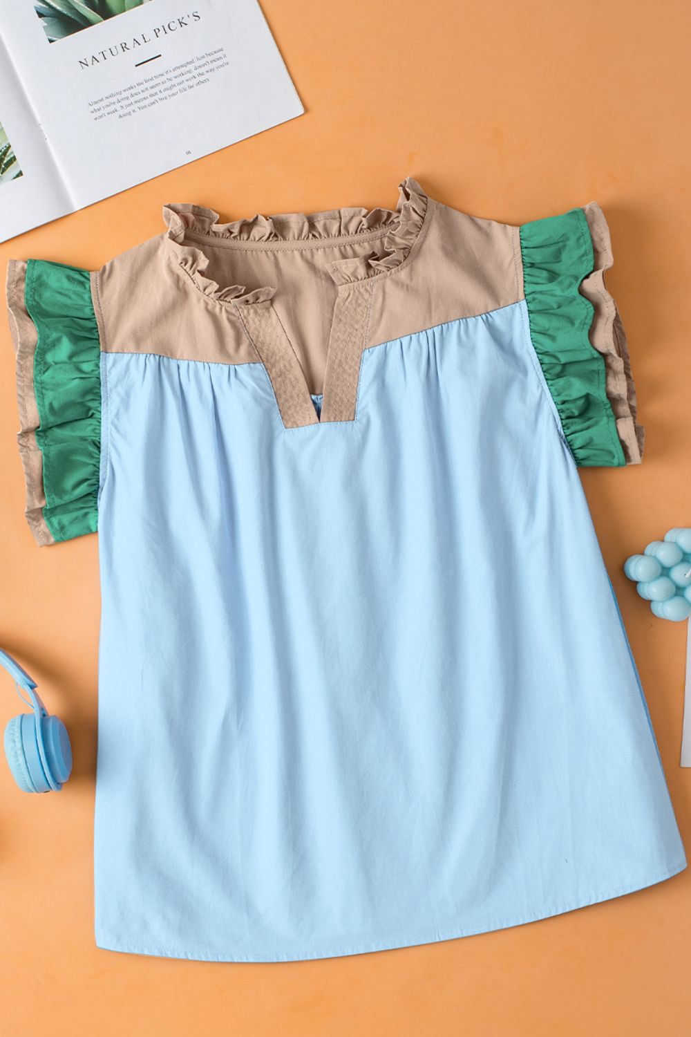 Color block notched ruffled cap sleeve blouse.